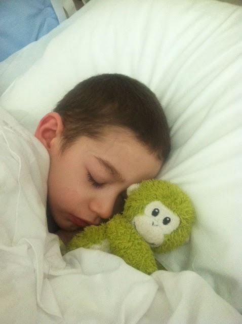 Aidan asleep with his stuffed monnkey